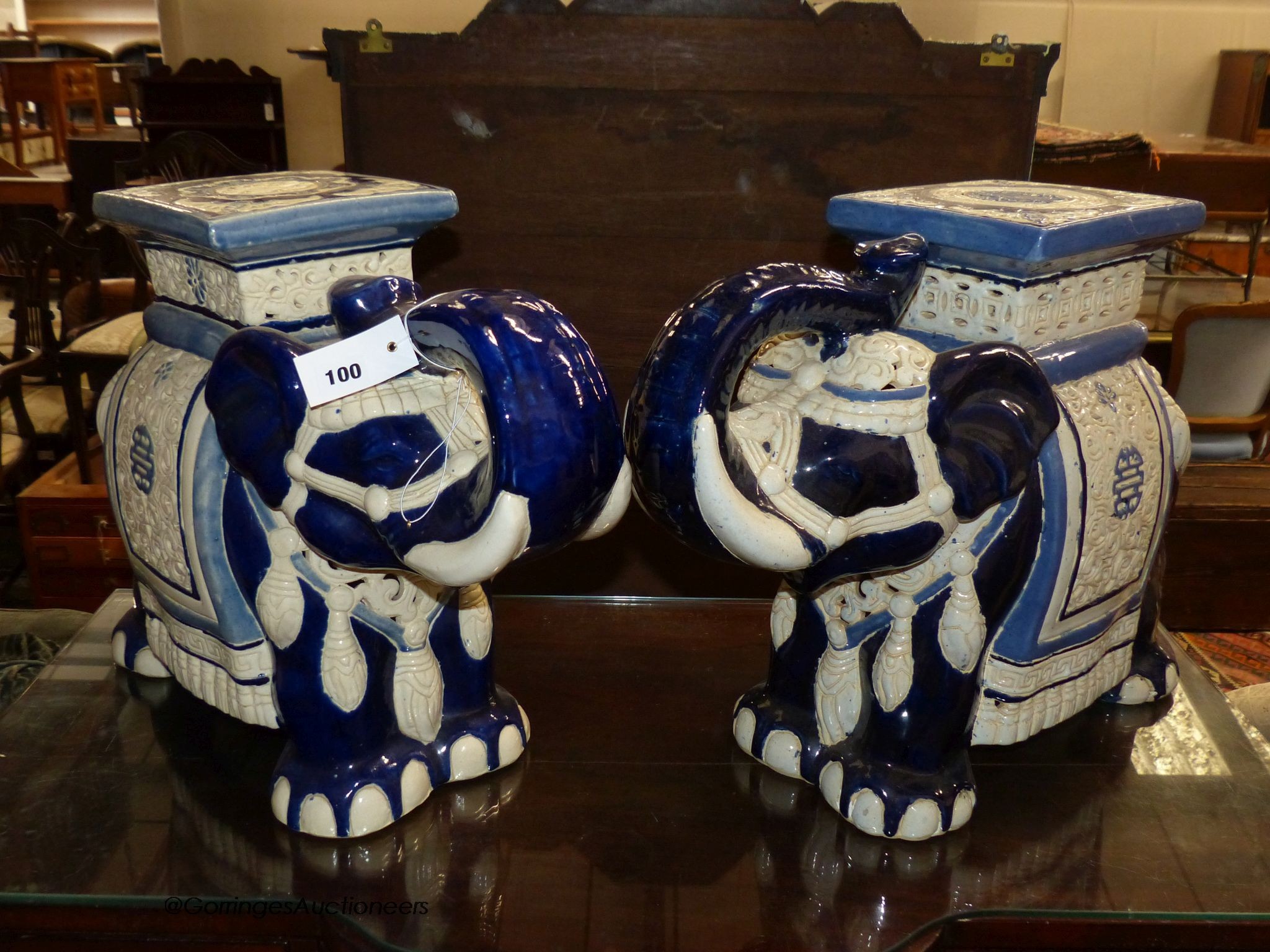 A pair of Chinese glazed earthenware elephant seats, width 60cm, height 43cm